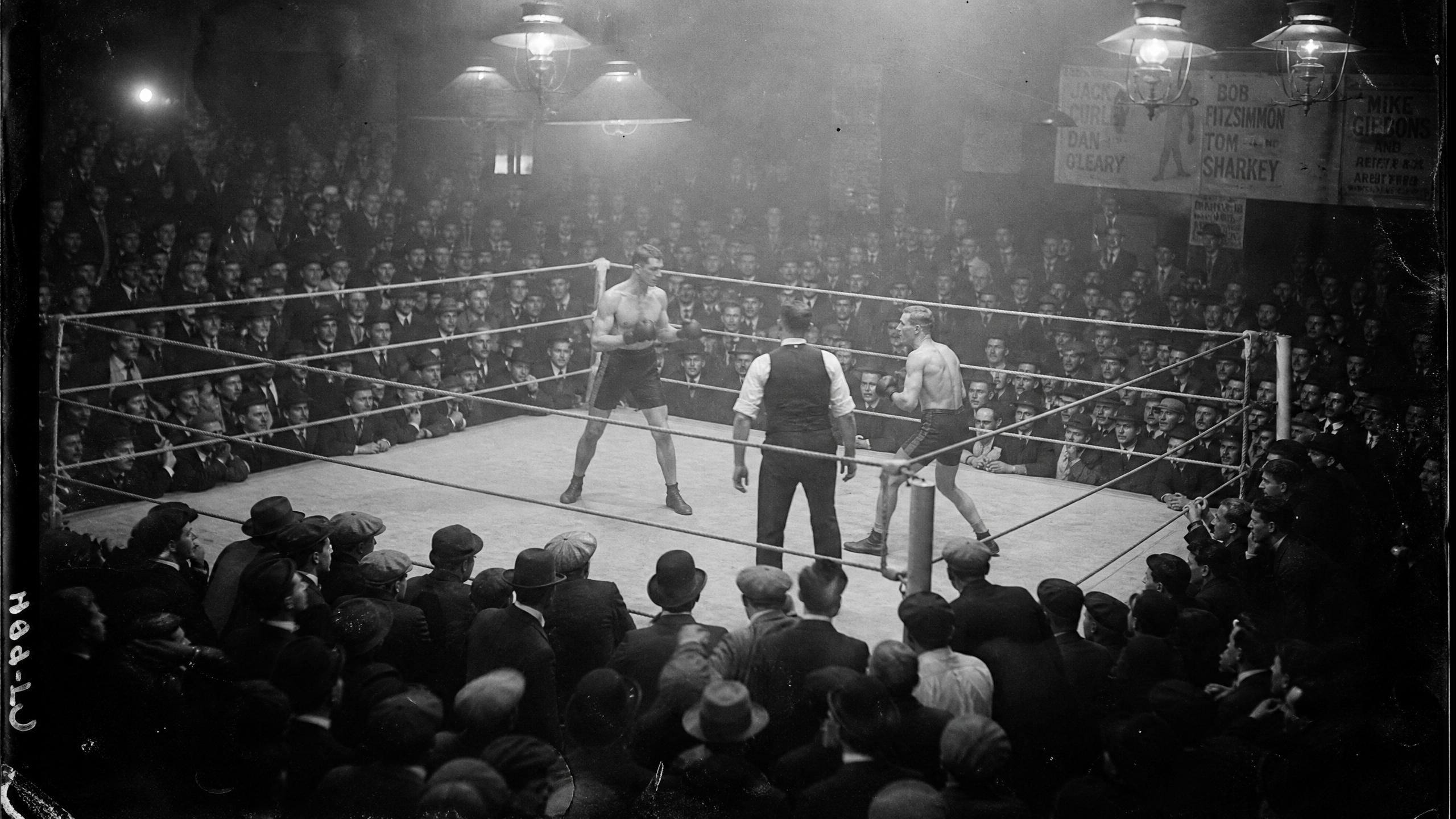 Fight night at the gymnasium, packed crowd around the ring